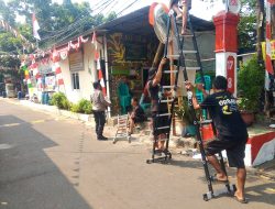 Sambut HUT ke-81 RI, Bhabinkamtibmas Mangga Dua Selatan Bantu Warga Pasang Bendera Merah Putih